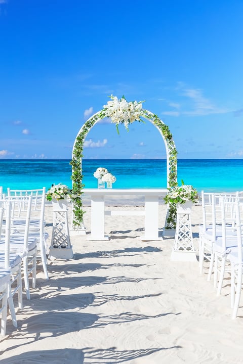 Tropical paradise wedding setting with floral arch