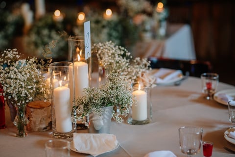 Intimate wedding table setting with candles and floral centerpiece
