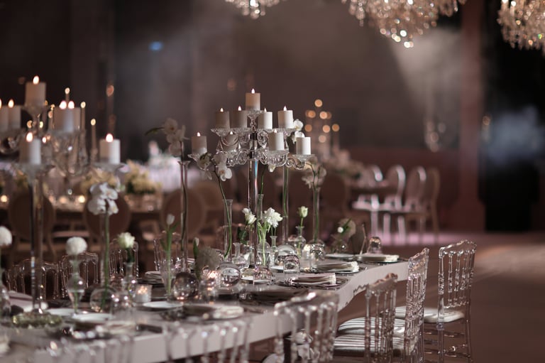 Elegant wedding reception with crystal candle holders and white floral arrangements